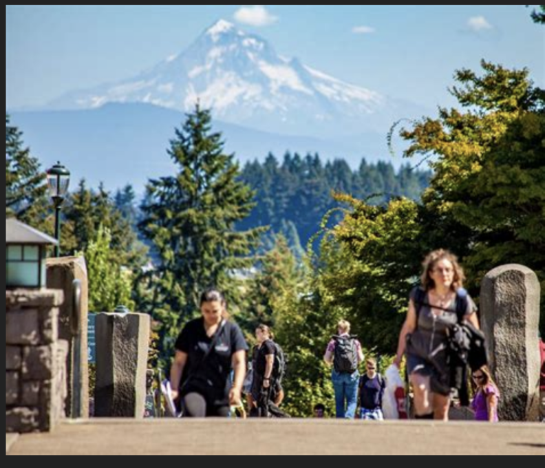 Students climb stairs against the backdrop of Mount Hood on a clear spring day. 